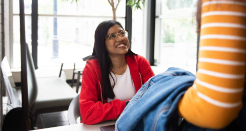An ask McGill student navigator assists a student in the Brown Building lobby